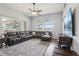 Large living room with a sectional sofa, hardwood floors, and a sliding glass door leading to the outside at 10435 Deerberry Dr, Land O Lakes, FL 34638