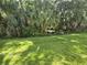 A well-maintained backyard features lush greenery and mature trees for added privacy at 10573 Oakside Dr, Palmetto, FL 34221