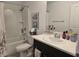 Bright bathroom featuring a tub, shower, single sink, and artwork at 10573 Oakside Dr, Palmetto, FL 34221