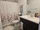 Well-lit bathroom featuring modern fixtures, a floral shower curtain, and stylish decor at 10573 Oakside Dr, Palmetto, FL 34221
