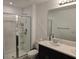 Modern bathroom with a glass shower, toilet, and double sink vanity, featuring neutral tones at 10573 Oakside Dr, Palmetto, FL 34221