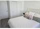 Bright bedroom featuring LVP flooring and a comfortable bed with decorative pillows at 10573 Oakside Dr, Palmetto, FL 34221