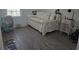 Cozy bedroom featuring a daybed, side table and wood flooring at 10573 Oakside Dr, Palmetto, FL 34221