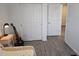 Bedroom with sliding closet doors and wood-look flooring at 10573 Oakside Dr, Palmetto, FL 34221