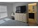 Bedroom with TV on dresser and view into bathroom at 10573 Oakside Dr, Palmetto, FL 34221