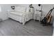 Cozy bedroom featuring a daybed, side table and wood flooring at 10573 Oakside Dr, Palmetto, FL 34221