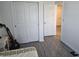 Bedroom with sliding closet doors and wood-look flooring at 10573 Oakside Dr, Palmetto, FL 34221