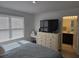Bedroom with TV on dresser and view into bathroom at 10573 Oakside Dr, Palmetto, FL 34221