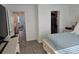 View of the bedroom from the door showing a closet and part of the adjacent room with a desk at 10573 Oakside Dr, Palmetto, FL 34221