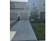 Inviting townhome showcasing a manicured lawn, gray exterior, and a convenient attached garage at 10573 Oakside Dr, Palmetto, FL 34221