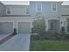 Inviting townhome showcasing a manicured lawn, gray exterior, and a convenient attached garage at 10573 Oakside Dr, Palmetto, FL 34221