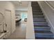 Entryway and staircase leading to an open floor plan with kitchen, dining, and living areas at 10573 Oakside Dr, Palmetto, FL 34221