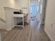 Hallway view of home office with desk, chair and printer on landing area with view into bedroom at 10573 Oakside Dr, Palmetto, FL 34221
