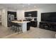 Modern kitchen with island, bar seating, stainless steel appliances, and adjacent living space at 10573 Oakside Dr, Palmetto, FL 34221
