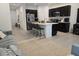 Modern eat-in kitchen with granite countertops, an island with barstool seating, and stainless steel appliances at 10573 Oakside Dr, Palmetto, FL 34221