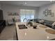 Bright kitchen with stainless steel sink set in an island and a view to the adjacent living room at 10573 Oakside Dr, Palmetto, FL 34221