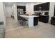 Modern eat-in kitchen with granite countertops, an island with barstool seating, and stainless steel appliances at 10573 Oakside Dr, Palmetto, FL 34221