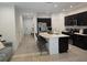 Spacious kitchen featuring a large island with bar seating, dark cabinetry, and stainless steel appliances at 10573 Oakside Dr, Palmetto, FL 34221
