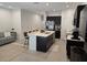 Open floor plan with kitchen island, bar seating, and a comfortable gray sectional sofa in the living area at 10573 Oakside Dr, Palmetto, FL 34221
