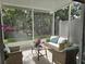 Relaxing screened in porch with wicker furniture, views of lush greenery, and natural light at 10573 Oakside Dr, Palmetto, FL 34221