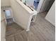 Staircase featuring luxury vinyl plank flooring leading to a hallway with a desk and chair at 10573 Oakside Dr, Palmetto, FL 34221