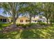 Expansive backyard featuring lush green grass, mature trees, and manicured landscaping for serene outdoor living at 11078 Heathrow Ave, Spring Hill, FL 34609