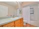 Traditional bathroom with a wooden vanity, laminate floors, and a shower-tub combo at 11078 Heathrow Ave, Spring Hill, FL 34609