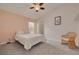 Welcoming bedroom with a window view, soft carpet, ceiling fan, and a comfortable bed, creating a cozy atmosphere at 11078 Heathrow Ave, Spring Hill, FL 34609