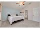 Comfortable bedroom with a light blue accent wall, soft carpet, and a ceiling fan, offering a tranquil retreat at 11078 Heathrow Ave, Spring Hill, FL 34609