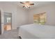 Bright bedroom with a window, soft carpet, ceiling fan and a king bed, creating a cozy and inviting atmosphere at 11078 Heathrow Ave, Spring Hill, FL 34609