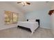 Inviting bedroom featuring a vaulted ceiling, soft carpet, ceiling fan, and a comfortable bed for a restful ambiance at 11078 Heathrow Ave, Spring Hill, FL 34609