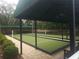 Bocce ball court shaded by mature trees, and surrounded by bushes and brick walk ways at 11078 Heathrow Ave, Spring Hill, FL 34609