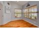 Cozy dining area with hardwood floors, large windows, and ample natural light at 11078 Heathrow Ave, Spring Hill, FL 34609