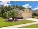 Inviting single-Gathering home with a two-car garage, beautiful landscaping, and a well-manicured lawn at 11078 Heathrow Ave, Spring Hill, FL 34609