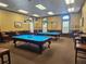 Elegant game room featuring two well-lit pool tables and comfortable seating for entertainment at 11078 Heathrow Ave, Spring Hill, FL 34609