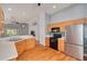 Modern kitchen with oak cabinets, stainless steel appliances, and an open view to the living area at 11078 Heathrow Ave, Spring Hill, FL 34609
