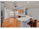 Open kitchen featuring a breakfast bar, wood cabinets, and modern appliances at 11078 Heathrow Ave, Spring Hill, FL 34609