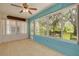 Bright sunroom with many windows offering natural light and views to the backyard at 11078 Heathrow Ave, Spring Hill, FL 34609