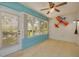 Bright sunroom with a view to the backyard and a fan offering comfort at 11078 Heathrow Ave, Spring Hill, FL 34609