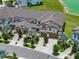 Aerial view of townhomes with well maintained landscaping, trees and sidewalks on a sunny day at 11287 Cay Spruce Way, San Antonio, FL 33576