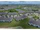 An aerial view of townhomes next to ponds, wetlands and a neighborhood at 11287 Cay Spruce Way, San Antonio, FL 33576