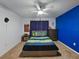 bedroom with a blue accent wall, ceiling fan, and playful decor at 11287 Cay Spruce Way, San Antonio, FL 33576