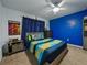 Bright bedroom features a colorful bed, ceiling fan, and playful decor at 11287 Cay Spruce Way, San Antonio, FL 33576