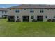 Wide shot of the home's exterior, complemented by a spacious lawn at 11287 Cay Spruce Way, San Antonio, FL 33576
