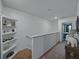 Upstairs hallway with carpet and view of bedroom and decorative shelving at 11287 Cay Spruce Way, San Antonio, FL 33576