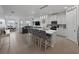 Open-concept kitchen featuring an island with barstool seating, modern appliances, and seamless flow to living area at 11287 Cay Spruce Way, San Antonio, FL 33576