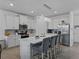 Modern kitchen with a large island, stainless steel appliances, white cabinets, and pendant lighting at 11287 Cay Spruce Way, San Antonio, FL 33576