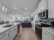 Open kitchen features stainless steel appliances and a view into the home's dining and living area at 11287 Cay Spruce Way, San Antonio, FL 33576