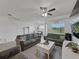 Inviting living room with modern ceiling fan, tile floors, and an adjacent dining area, perfect for entertaining at 11287 Cay Spruce Way, San Antonio, FL 33576