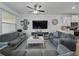 Spacious living room with tile flooring, ceiling fan, and a view into the kitchen at 11287 Cay Spruce Way, San Antonio, FL 33576